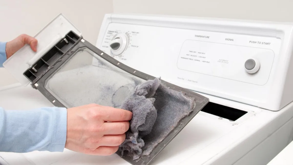Cleaning dryer lint trap with brush