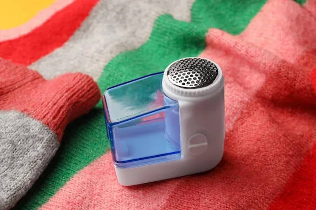 Electric fabric shaver removing pills from a wool sweater