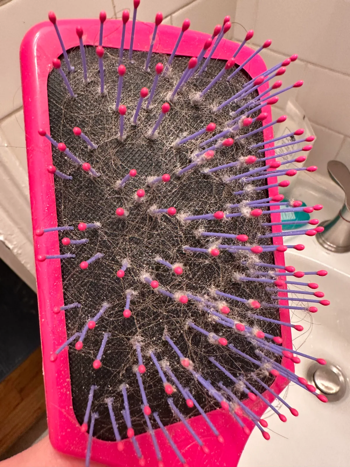 Hairbrush with lint and hair buildup on bristles