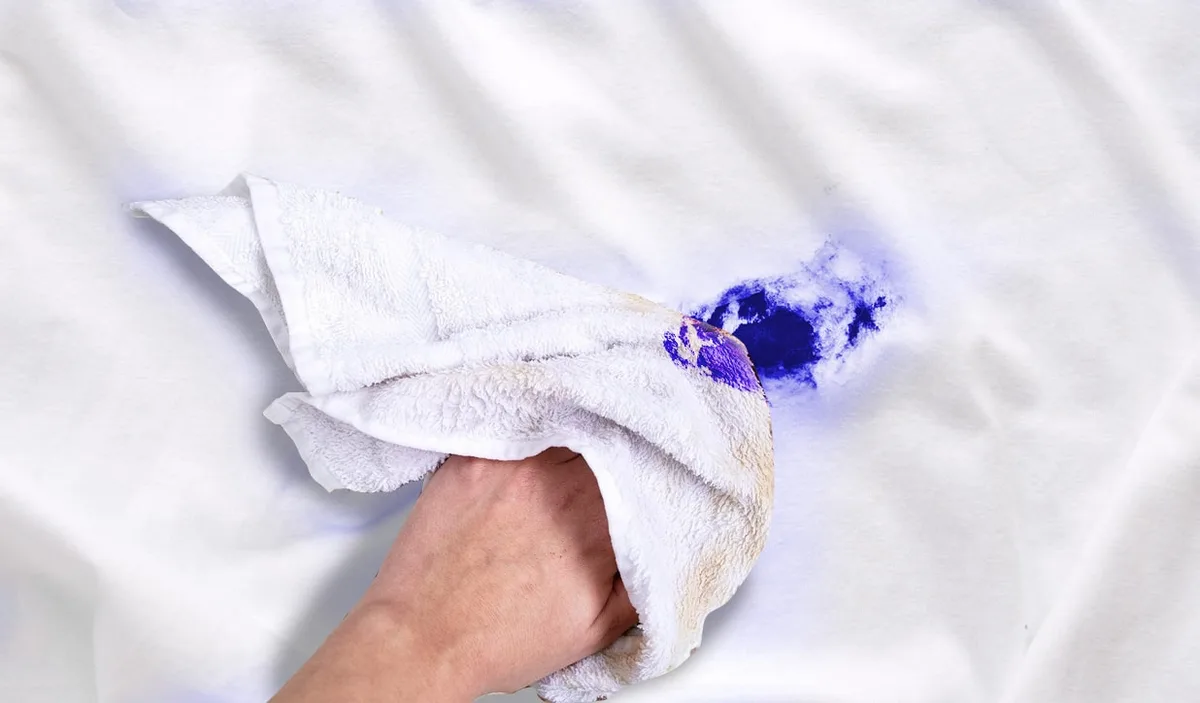 Ink stain on white fabric being treated